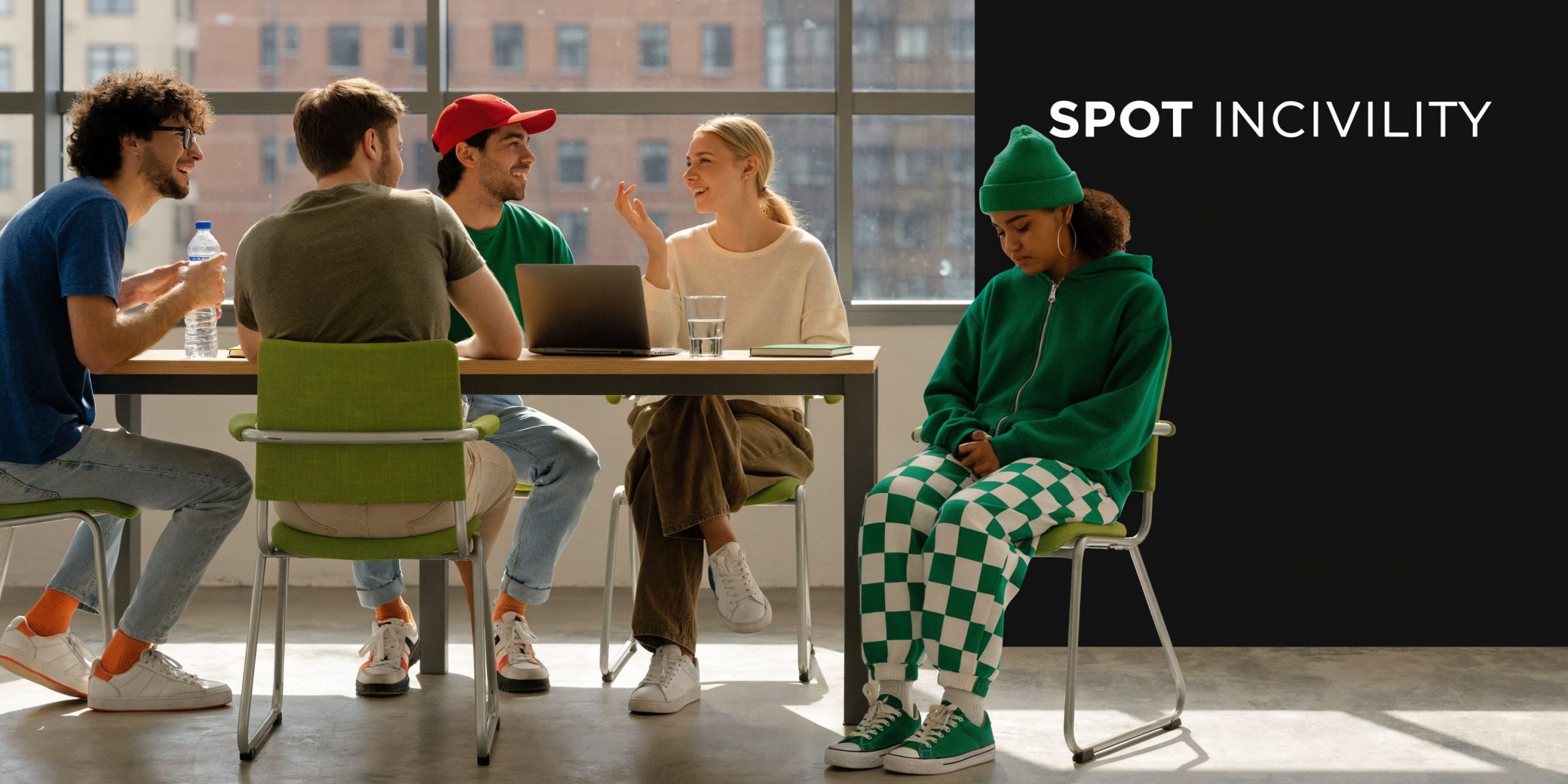 A group of colleagues chatting at a table while one person sits excluded and isolated nearby.